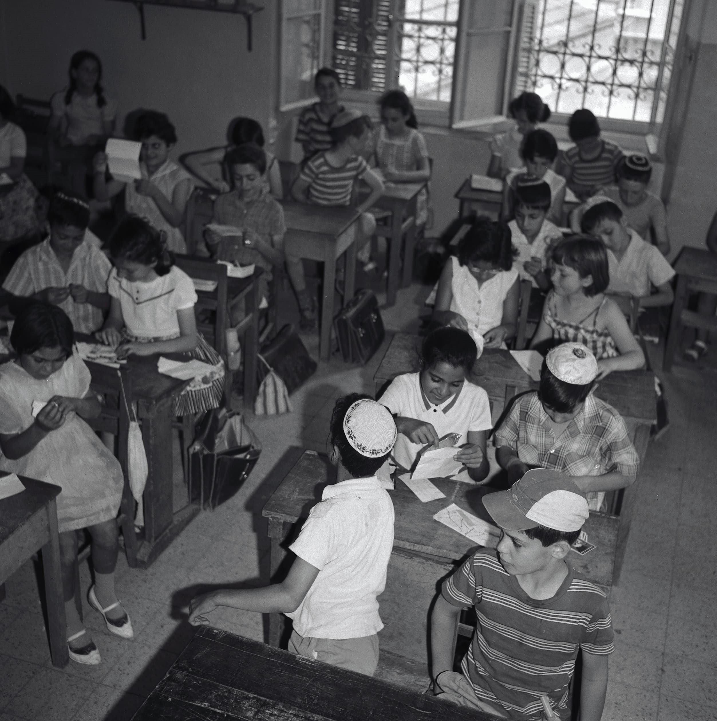 Schoolchildren in Jerusalem receive letters during a lesson, May 1963, Jerusalem. Credit: David Hirschfeld, KKL-JNF Photo Archive.