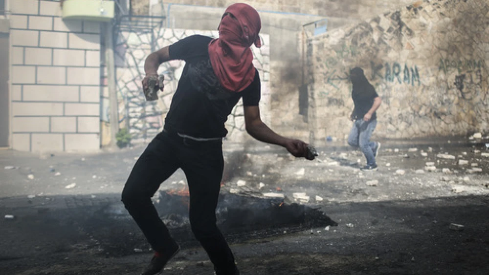 On Oct. 30, 2014, a Palestinian rock thrower targets Israeli police in Jerusalem's Abu Tor neighborhood, near the house of the Palestinian man suspected of attempting to assassinate Temple Mount activist Yehudah Glick. Credit: Hadas Parush/Flash90.