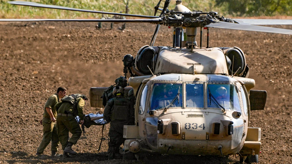 Israeli soldiers evacuate a person who was wounded by a Lebanese missile near the Israeli border with Lebanon, Oct. 22, 2024. Photo by Ayal Margolin/Flash90.
