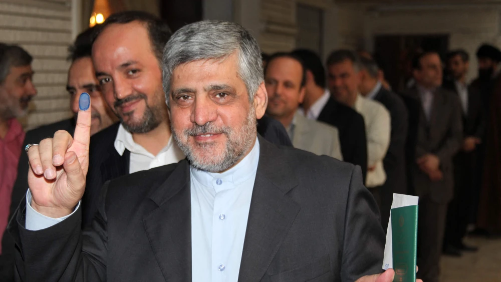 Iranian Ambassador to Syria Mohammad Reza Sheibani shows his ink-stained finger as he votes in the first round of the Iranian presidential election, June 14, 2013. Photo by AFP via Getty Images.