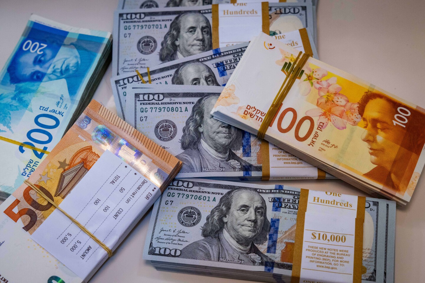 Illustration of American 100 dollar bills, 100 and 200 shekel bills and 50 euro bills, May 19, 2025. Photo by Nati Shohat/Flash90.