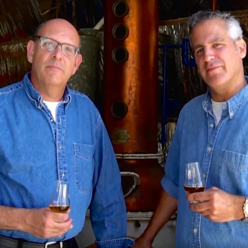 Legends Distillery founders Alan Cohl (left) and Noam Cohen in front of distilling equipment. Credit: Legends Distillery.