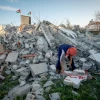 A Palestinian man walks on the rubble of the family house of suspected Palestinian terrorist Yazan Mughamis after it was demolished by Israeli forces in the West Bank town of Birzeit on March 5, 2020. Photo by Flash90.