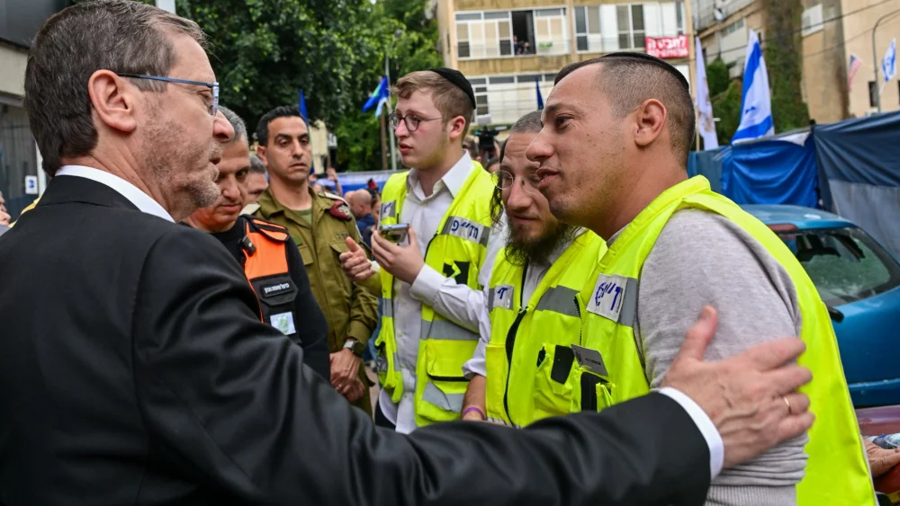 Israeli President Isaac Herzog visits the site of a deadly cluster-missile strike in Ramat Gan on March 18, 2026. Source: @Isaac_Herzog/X.