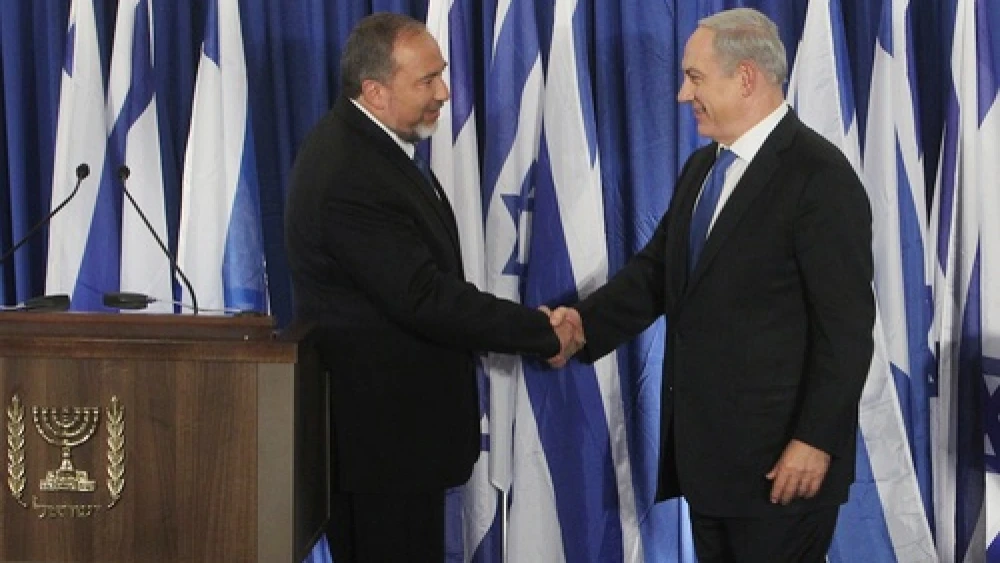 Click photo to download. Caption: Prime Minister Benjamin Netanyahu of the Likud party (R) and Foreign Minister Avigdor Lieberman of the Yisrael Beiteinu party shake hands at a joint press conference Oct. 25 announcing that the two parties are joining forces ahead of the upcoming Israeli general elections. Credit: Miriam Alster/FLASH90.