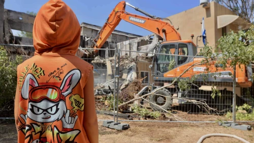 A bulldozer destroys a house that was damaged during the Oct. 7, 2023, massacre in Kibbutz Be'eri, near the Israeli border with the Gaza Strip, July 7, 2024. Photo by Oren Cohen/Flash90.