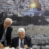 P.A. leader Mahmoud Abbas (right) and Palestinian chief negotiator Saeb Erekat sign an application to U.N. agencies in the West Bank city of Ramallah on April 1, 2014. Photo by Issam Rimawi/Flash90.