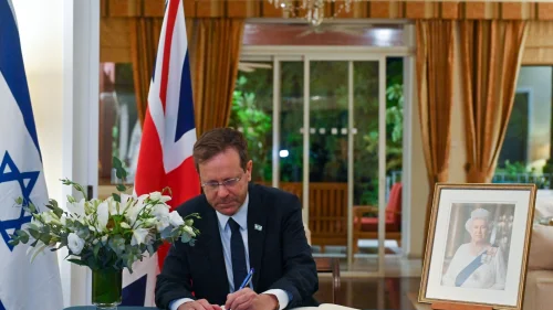Israeli President Isaac Herzog signs the condolence book for Queen Elizabeth II at the residence of the British ambassador to Israel in Ramat Gan on September 10, 2022. Credit: Koby Gideon/GPO.