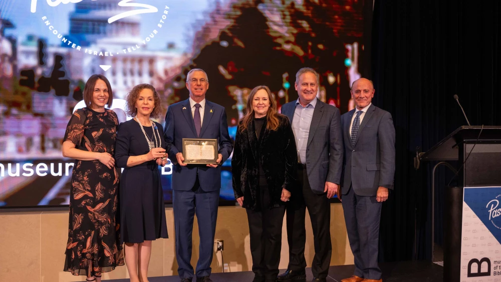 Ambassador Herzog holding a copy of the oldest Hebrew book in the world together with his wife Shirin, Steve and Jackie Green, Rivka Kidron, and CEO of Museum of the Bible Dr. Carlos Campo. Credit: Cade Chudy.