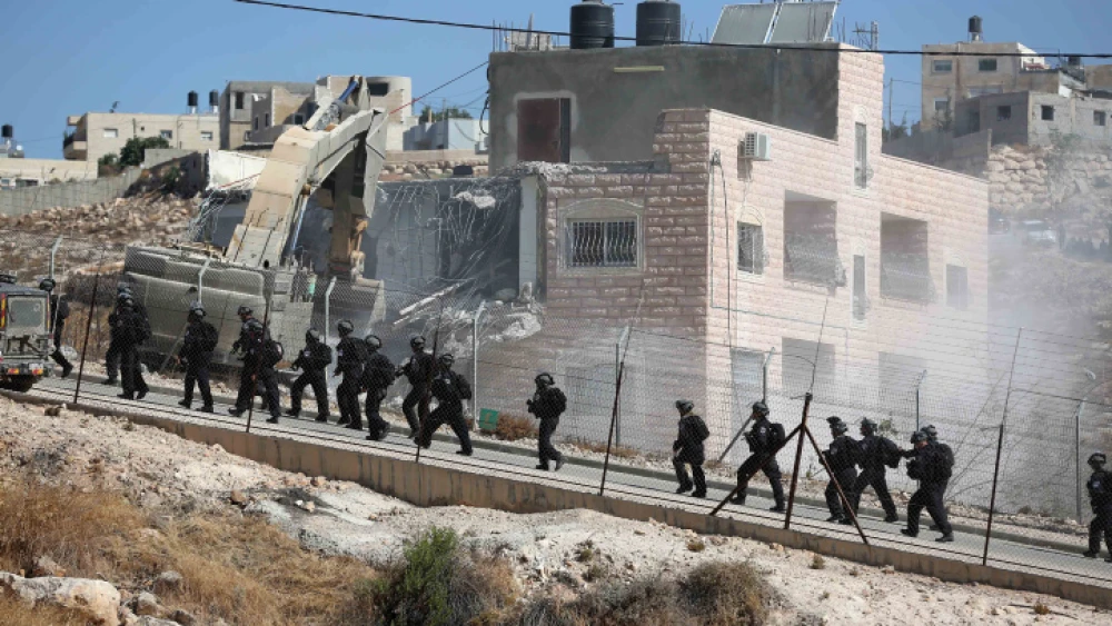 An Israeli military bulldozer demolishes a building in Sur Baher on July 22, 2019. Photo by Wisam Hashlamoun/Flash90.