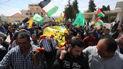 In March 2016 in the West Bank village of Deir Debwan, Palestinian mourners chant slogans while carrying the body of Mahmoud Shalan, a Palestinian-American terrorist who had tried to murder Israelis before security forces killed him. Credit: Photo by Flash90.