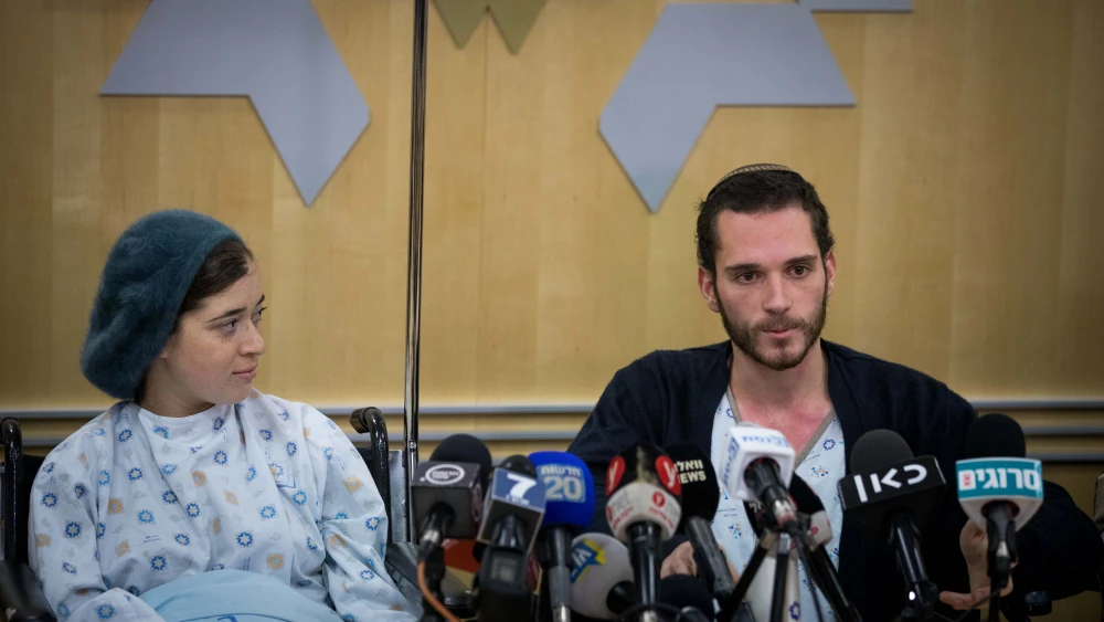 Shira and Amichai Ish-Ran, who were injured in a drive-by shooting on Dec. 9, 2018 when a Palestinian opened fire on Israelis near the settlement of Ofra, answer questions at a press conference at Shaare Zedek Medical Center on Dec. 16, 2018. Shira was 30 weeks pregnant at the time of the attack. Their baby son was delivered by an emergency Caesarean section, but died a few days later. Credit: Yonatan Sindel/Flash90.