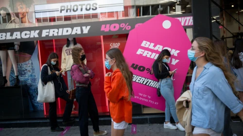 Israelis stand in line outside a clothing shop advertising Black Friday sales in Tel Aviv on Nov. 25, 2020. Photo by Miriam Alster/Flash90.