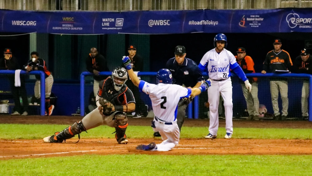 Team Israel scores a run during its Olympic qualifying game against the Netherlands. Credit: Margo Sugarman.