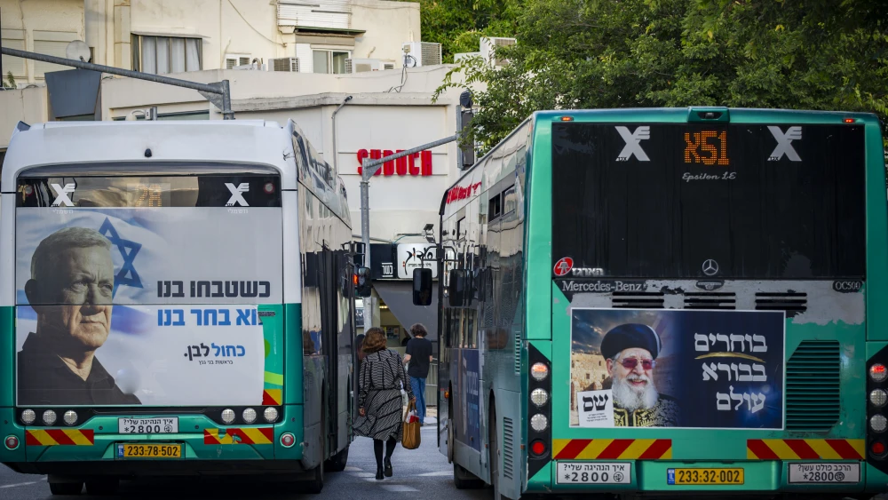 Election campaign posters for the Blue and White party, featuring party chairman Benny Gantz, and the Shas party are displayed on buses in the northern Israeli city of Haifa, ahead of Israel’s upcoming general elections, October 18, 2026. Photo by Sharon Leibel/Flash90