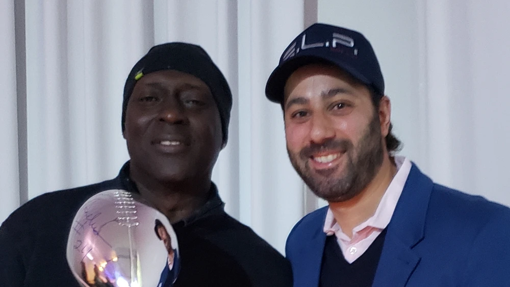 Eli with Otis Anderson, the 1991 Super Bowl MVP from the New York Giants. Credit: Courtesy.