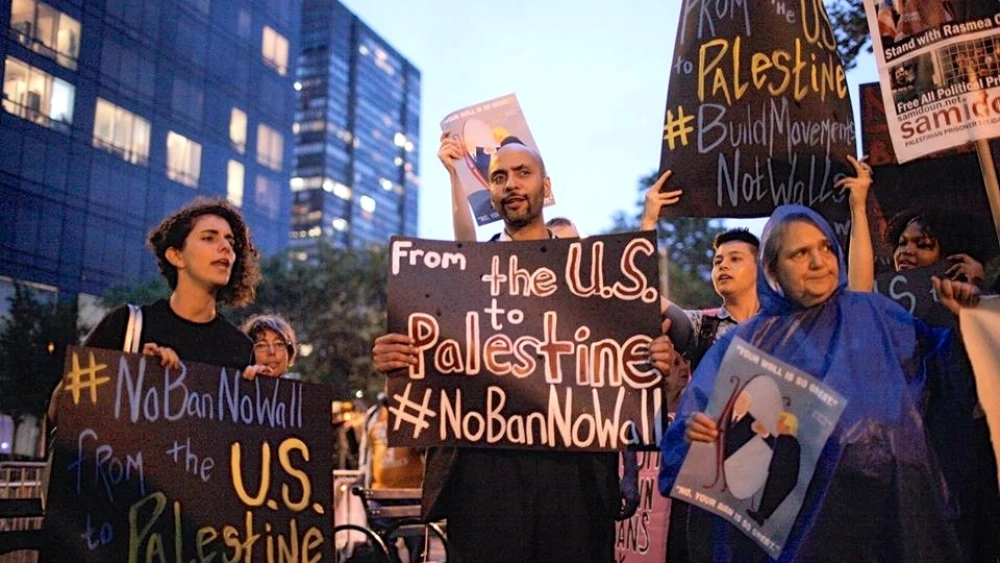Protesters compare U.S. President Donald Trump's proposed U.S.-Mexico border wall to Israel's West Bank security fence at a Jewish Voice for Peace (JVP) demonstration in New York City last September. Credit: JVP via Facebook.