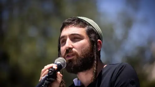 Activist Zvi Sukkot speaks during a protest outside the Prime Minister's Office in Jerusalem, May 8, 2022. Photo by Yonatan Sindel/Flash90.