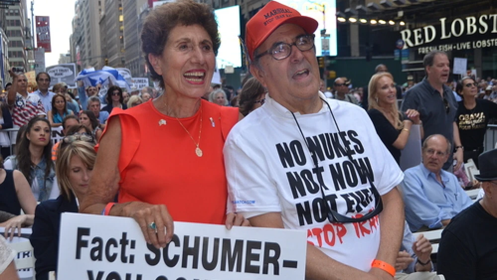 Pictured in front, Helen Freedman, director of Americans for a Safe Israel, with Charles Bernhardt at a July 22 rally against the Iran deal in New York City. The sign held by Freedman targets the vote of U.S. Sen. Chuck Schumer (D-N.Y.), who later announced he would oppose the deal. But the Senate will fall short of producing the 67 anti-deal votes needed to override a presidential veto of its collective decision. Credit: Maxine Dovere.