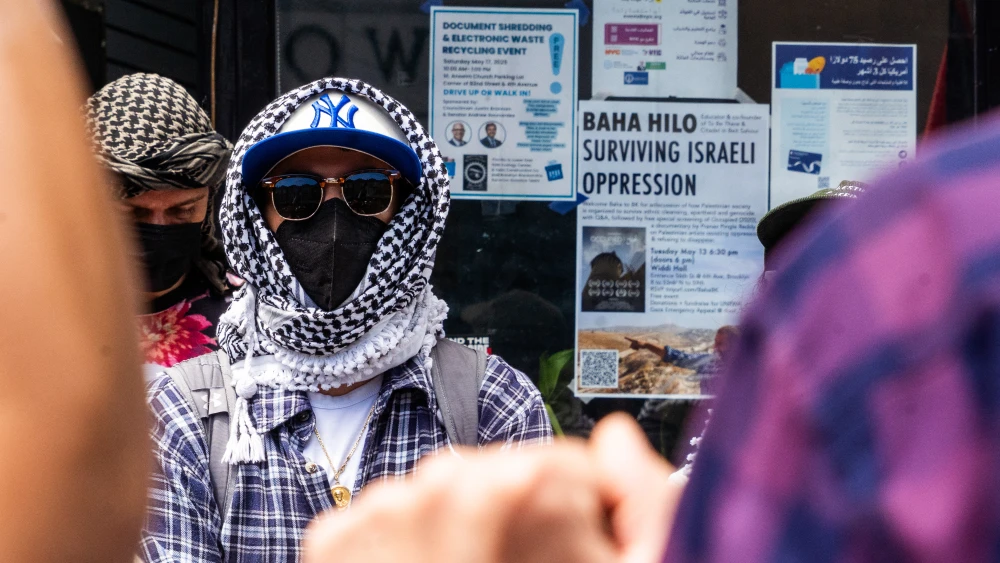 An anti-Israel protester wearing a keffiyeh mask and sunglasses in Brooklyn, N.Y., May 10, 2025. Photo by Madison Swart/Hans Lucas/AFP via Getty Images.