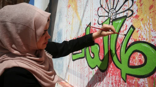 Palestinian artists paint a mural that reads "No to Violence" during a protest against violence against women in Rafah in the southern Gaza Strip, on Sept. 26, 2019. Photo by Abed Rahim Khatib/Flash90.