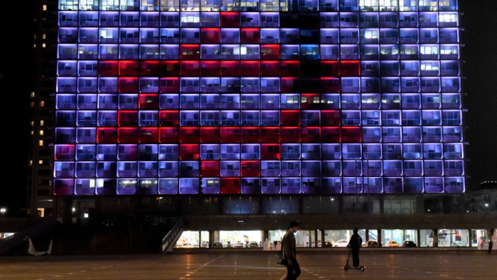 Tel Aviv City Hall on Rabin Square is lit up with a red Magen David Adom to show support for the medical staff battling the coronavirus outbreak in the country, March 30, 2020. Photo by Avshalom Sassoni/Flash90.
