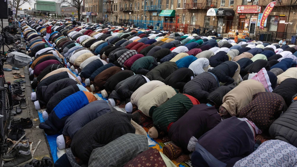 The Bangladeshi Muslim community celebrates Eid al-Fitr, the end of a month of fasting during Ramadan, with a large group prayer on a blocked-off street in the Kensington neighborhood of Brooklyn, N.Y., on April 10, 2024. New York City and the greater metropolitan area are home to an estimated 1.5 million Muslims from a variety of countries and sects. Photo by Andrew Lichtenstein/Corbis via Getty Images.