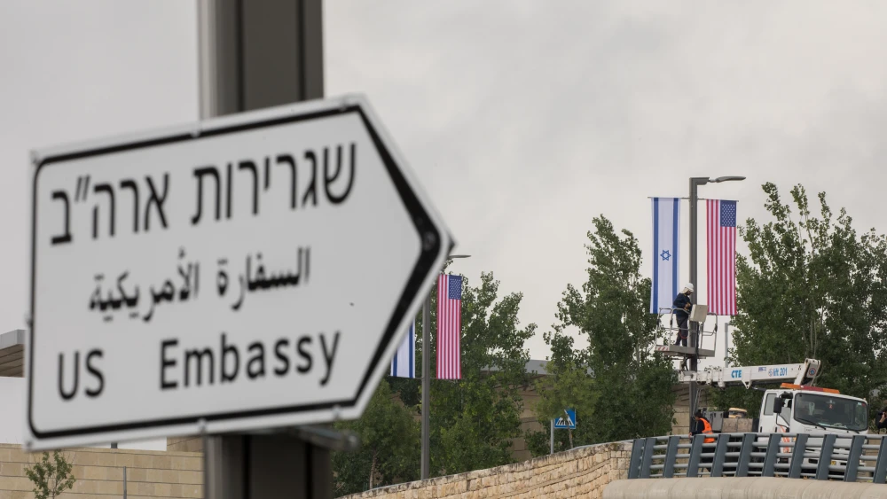Jerusalem municipality worker hangs an American and Israeli flags near the U.S. consulate in Jerusalem on May 7, 2018. Credit: Yonatan Sindel/Flash90.