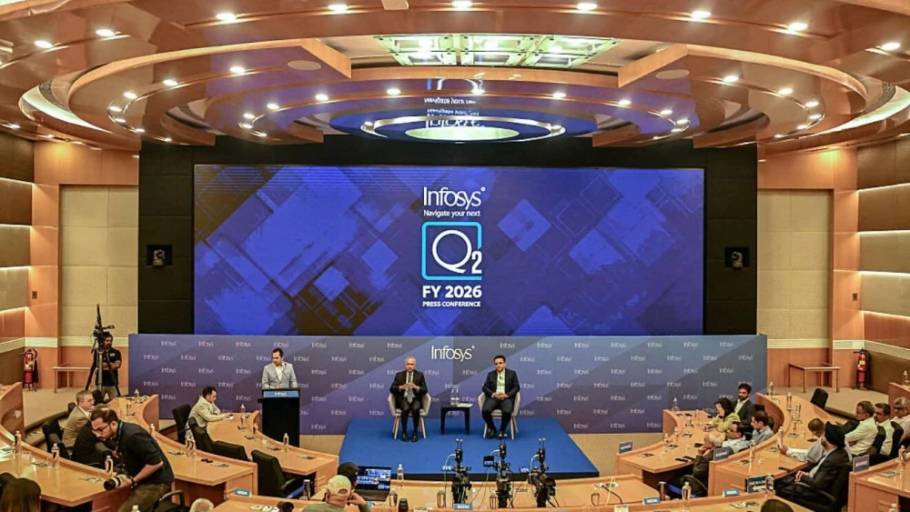 The Infosys group's CEO and Managing Director Salil Parekh (center left) and Executive Vice President and CFO Jayesh Sanghrajka (center right) hold a press conference to announce second quarter results in Bengaluru, India, on Oct. 16, 2025. Photo by Idrees Mohammed/AFP via Getty Images.