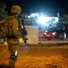 Israeli troops stand near the scene of a suspected car-ramming attack at the entrance to the village of Husan in Judea, June 23, 2018. Photo by Aharon Krohn/Flash90.