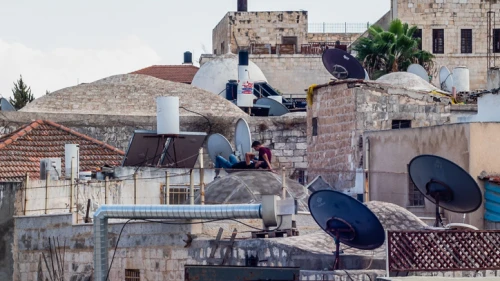 People rest on a rooftop in Jerusalem's Old City on Sept. 7, 2018. Photo by Dario Sanchez/Flash90.