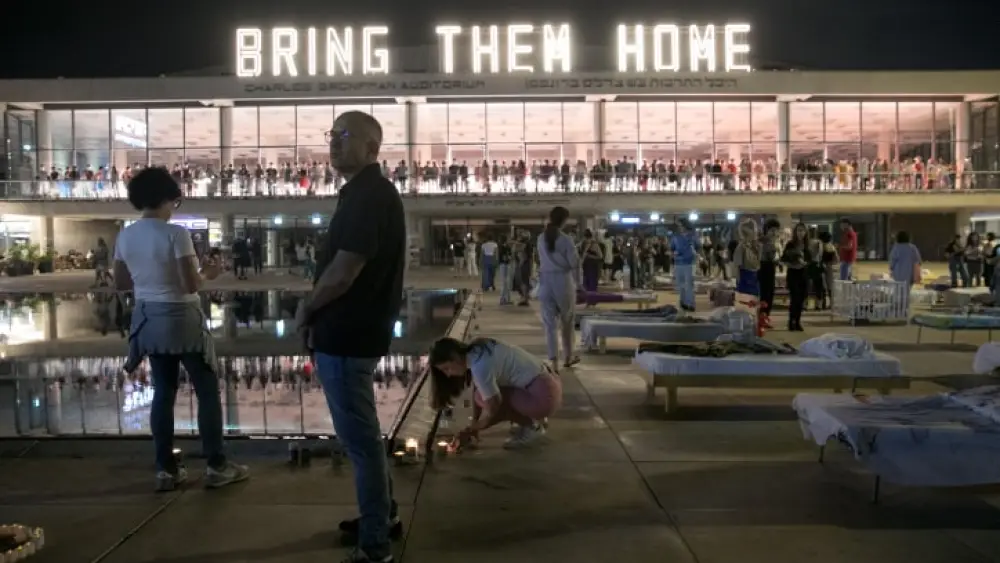 Israelis at Habimah Square in Tel Aviv walk by beds representing the number of hostages held captive by Hamas terrorists in the Gaza Strip, Nov. 11, 2023. Photo by Miriam Alster/Flash90.