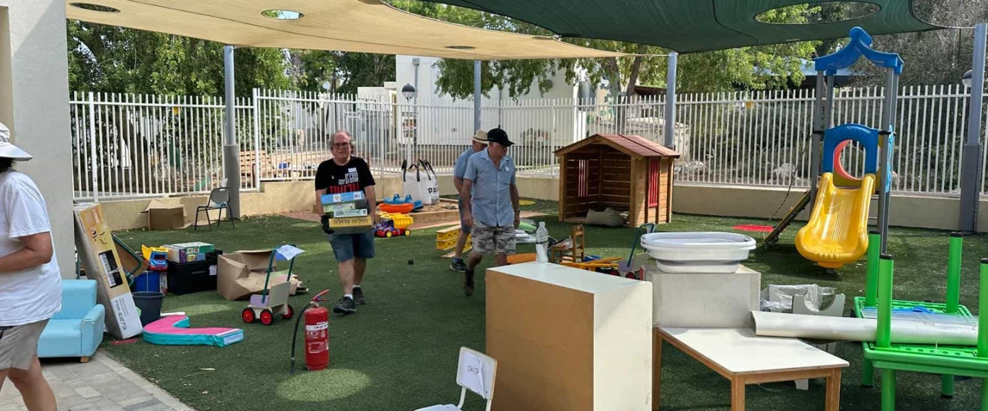 Volunteers set up a kindergarten playground at Kibbutz Nir Am, Aug. 20, 2024. Photo by Debbie Dash.