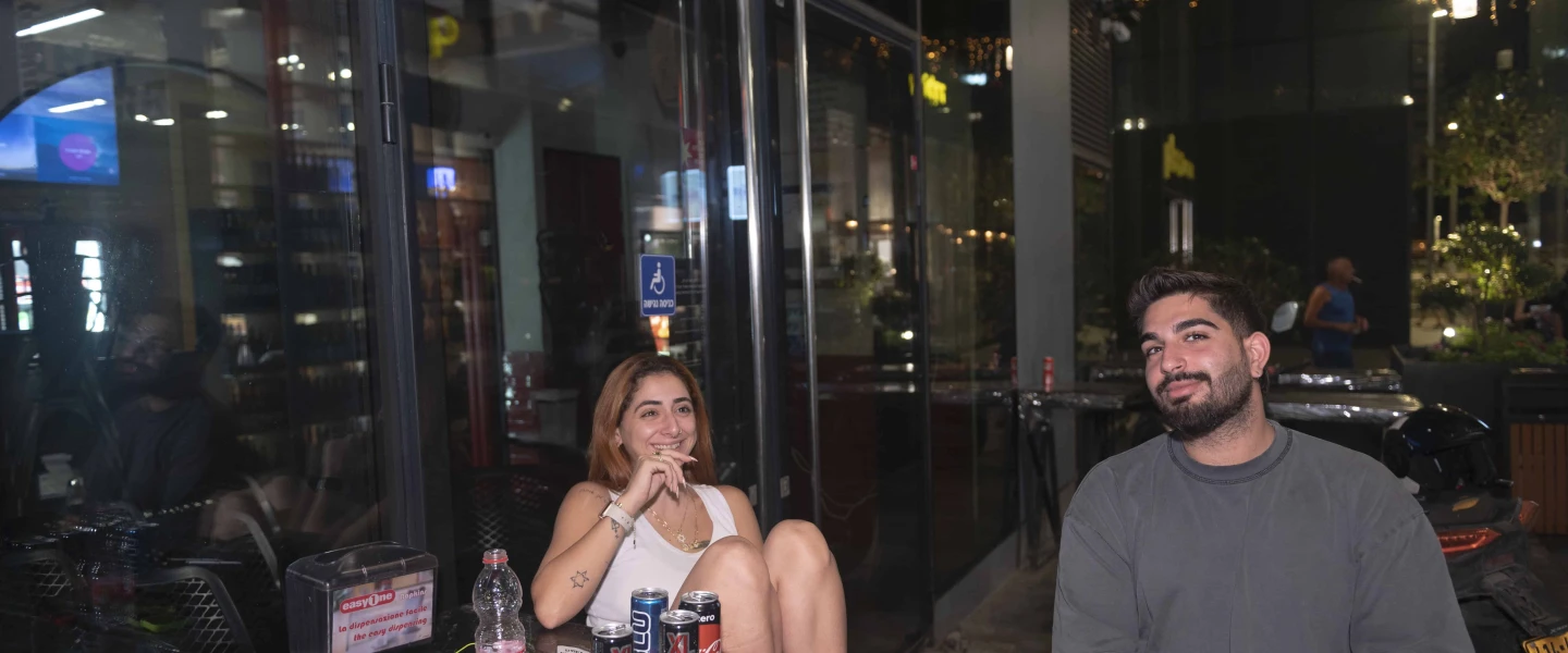 Noam Swissa (left) and Asif Korliker sit outside their hotel in Tel Aviv on Sept. 7, 2024. Photo by Canaan Lidor.