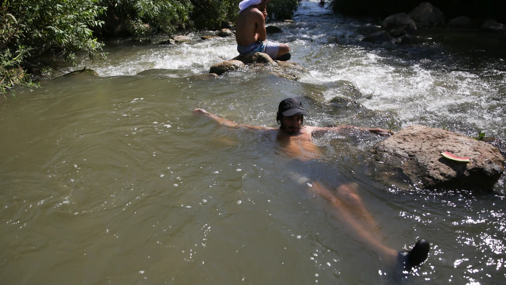 Israelis cool off in a stream in the Golan Heights, although some remain off-limits for swimmers because of health reasons, Aug. 10, 2018. Photo by David Cohen/Flash90.