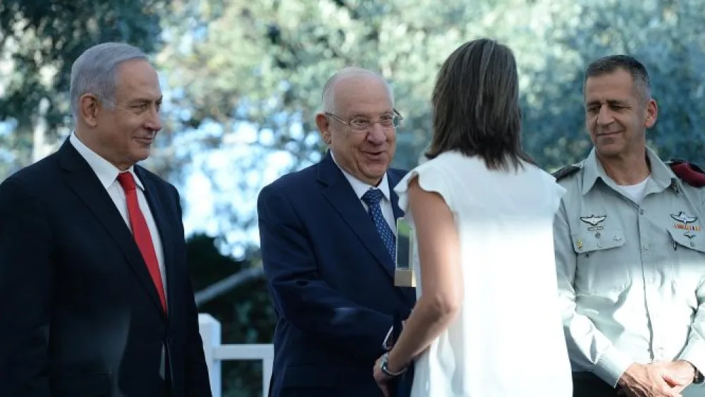 From left: Prime Minister Benjamin Netanyahu, President Reuven Rivlin, and IDF Chief of Staff Lt. Gen. Aviv Kochavi congratulate one of the recipients of this year's Israel Defense Prize at the Prime Minister's Resident in Jerusalem on July 2, 2019. Photo: GPO/Haim Zach.