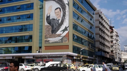 A mural featuring Syrian President Bashar Assad in Latakia, Syria. Credit: Emesik via Wikimedia Commons.