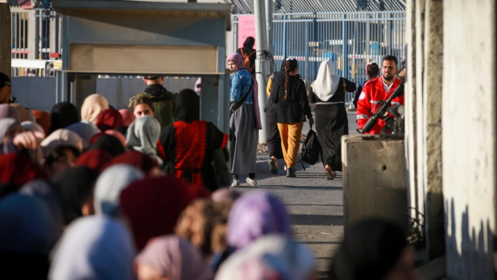 Palestinian women cross the Qalandiya checkpoint, outside Ramallah, on April 15, 2022. Photo by Flash90.