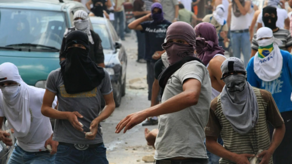 Palestinians hurl stones at Israeli forces during clashes in the eastern Jerusalem neighborhood of Ras al-Amud, on Friday, Oct 9, 2009. Photo by Kobi Gideon/Flash90.