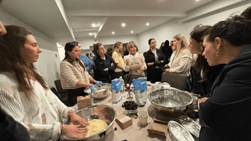 Social media influencer Charlene Aminoff (center), leads the ECP Challah Bake at Magen David Manhattan. Credit: Courtesy of the Orthodox Union.