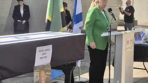 Head of MASHAV Eynat Shlein speaks at the farewell ceremony for Tanzanian agricultural intern Joshua Luito Mollel at Ben-Gurion Airport, Nov. 18, 2025, honoring his memory and expressing condolences on behalf of Israel’s international development agency. Source: @EynatShlein/X.