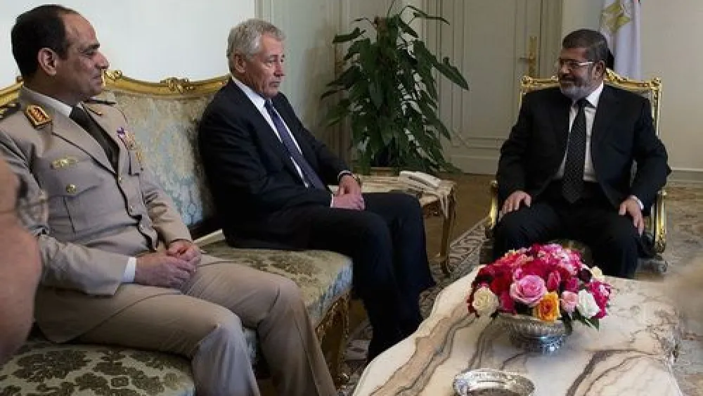From left to right, former Egyptian defense minister Abdel Fattah El-Sisi, former U.S. defense secretary Chuck Hagel, and former Egyptian president Mohammed Morsi meet in Cairo on April 24, 2013. El-Sisi, who is now Egypt's president, was instrumental in bringing about Morsi's ouster in July 2013. Credit: Erin A. Kirk-Cuomo via Wikimedia Commons.