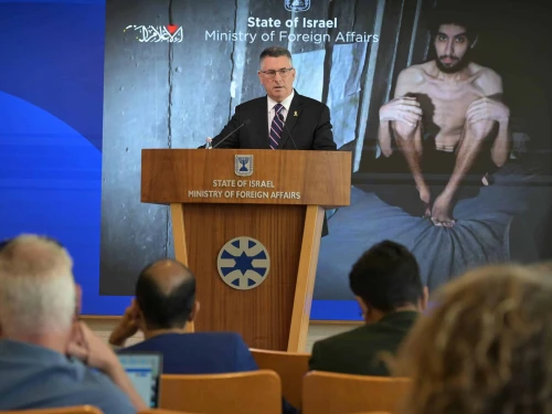 Foreign Minister Gideon Sa’ar speaks to foreign reporters in Jerusalem, standing before an image of Hamas captive Evyatar David, Aug. 4, 2025. Photo by Shlomi Amsalem/GPO.