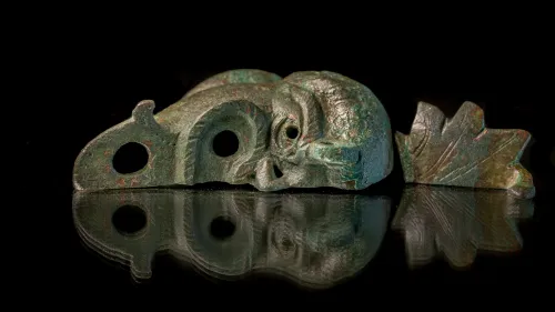 A rare bronze oil lamp, shaped like a grotesque face cut in half, was discovered during excavations in Jerusalem’s City of David National Park, May 5, 2021. Credit: Israel Antiquities Authority.