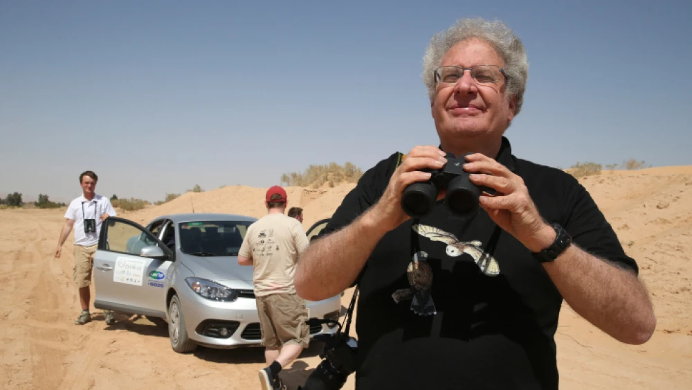 Professor Yossi Leshem, director of the International Center for the Study of Bird Migration of Latrun, seen together with contestants looking through their binoculars in the "First International Champions of the Flyway"—a 24-hour bird-spotting competition in Eilat and the Negev, April 1, 2014. Photo by Nati Shohat/Flash90.