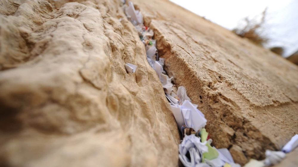 Handwritten notes placed between the ancient stones of the Western Wall in the Old City of Jerusalem, Nov. 14, 2018. Photo by Mendy Hechtman/Flash90.