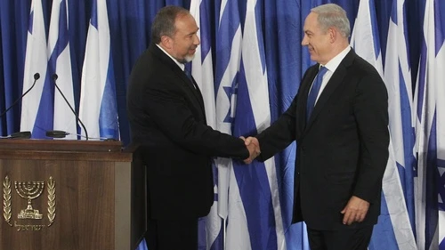 Click photo to download. Caption: Prime Minister Benjamin Netanyahu of the Likud party (R) and Foreign Minister Avigdor Lieberman of the Yisrael Beiteinu party shake hands at a joint press conference Oct. 25 announcing that the two parties are joining forces ahead of the upcoming Israeli general elections. Credit: Miriam Alster/FLASH90.