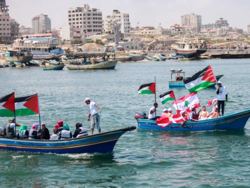 Palestinians hold flags during a rally at the seaport of Gaza City marking the fifth anniversary of the “Mavi Marmara” Gaza flotilla, May 31, 2015. Photo by Aaed Tayeh/Flash90.