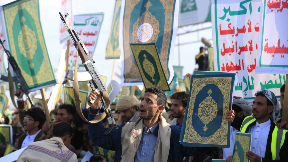 Yemenis brandish weapons and copies of the Quran, Islam's holy book, during a demonstration over remarks made by a candidate for the U.S. Senate on the Quran in the Yemeni capital Sana'a, which is under Houthi control on Dec. 19, 2025. Photo by Mohammed Huwais/AFP via Getty Images.