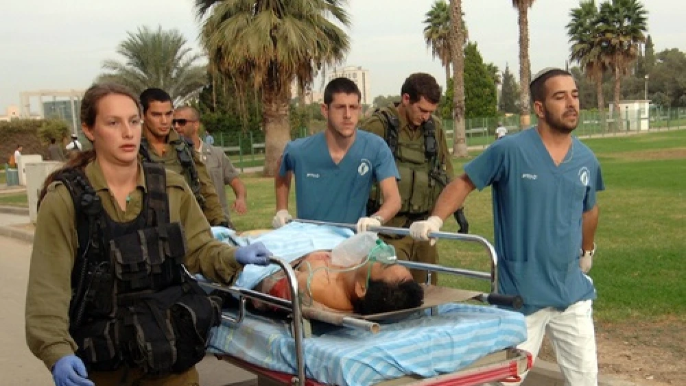 Click photo to download. Caption: Medics carry a man wounded by a mortar shell fired from the Gaza Strip, for treatment in Soroka hospital in Beersheba, southern Israel, Wednesday, Oct. 24, 2012. Credit: Dudu Greenspan/Flash90.